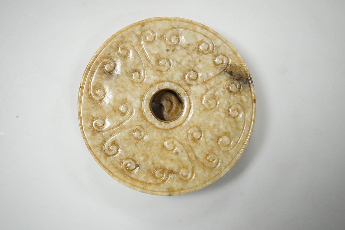 A Chinese russet jade bi disc, 5cm diameter